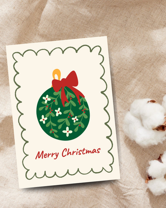 Kerstkaart met kerstbal en rode strik