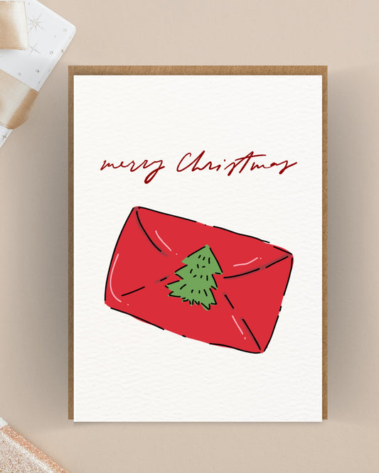 Kerstkaart met rood cadeau envelopje