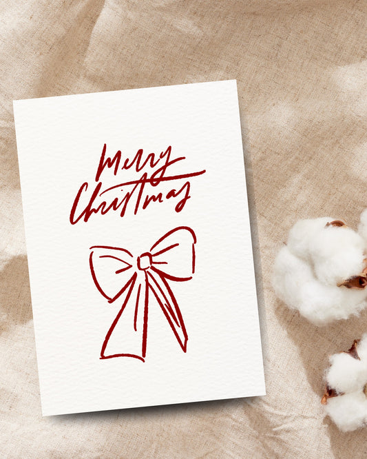 Minimalistische kerstkaart met rode strik