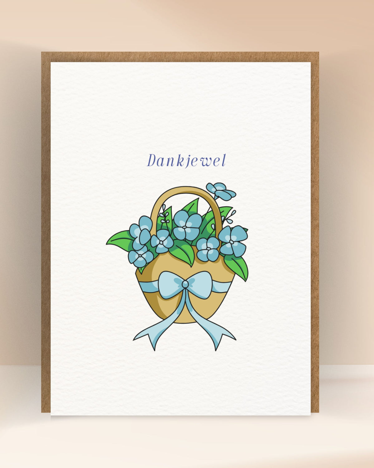 Bedankkaart met de tekst ‘Dankjewel’ en een bloemenmand met blauwe bloemen en strik