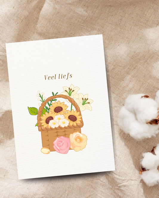 ‘Veel liefs’-wenskaart met een bloemenmand vol zonnebloemen, lelies, rozen en madeliefjes